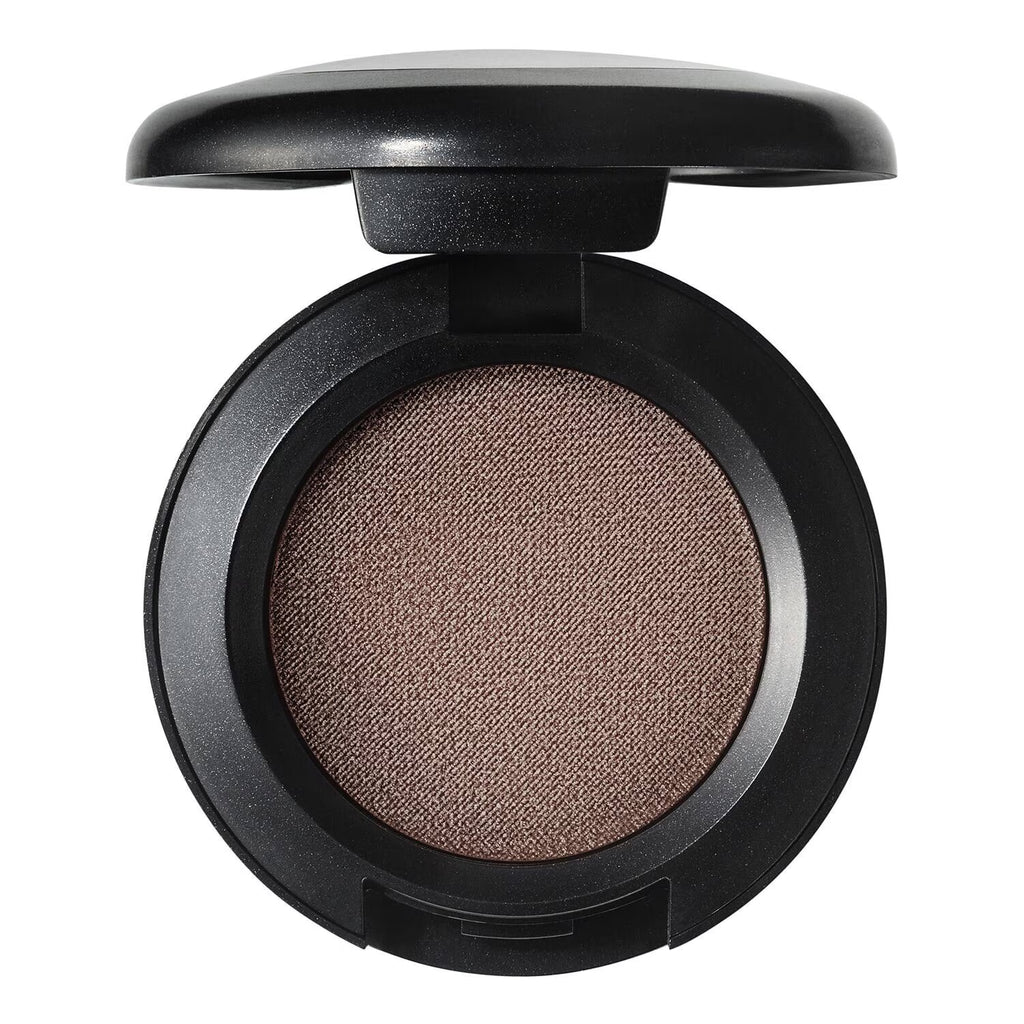 An open round makeup compact with a black casing and a warm tan-brown pressed powder pan, shown on a plain white background.
