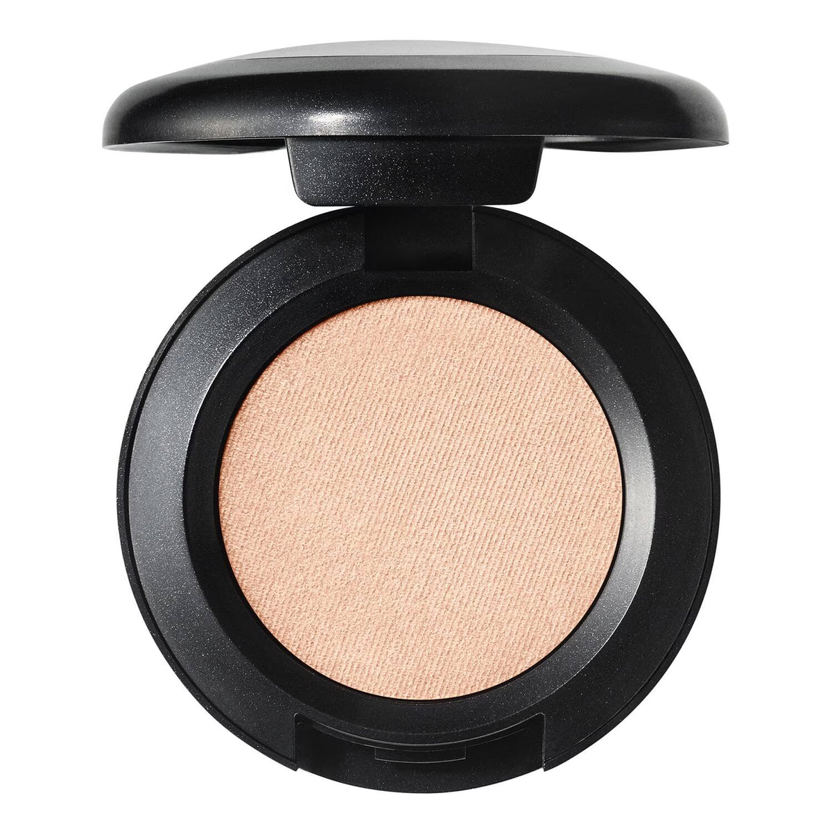 An open round makeup compact with a black casing and a light peach-beige pressed powder pan, photographed on a plain white background.