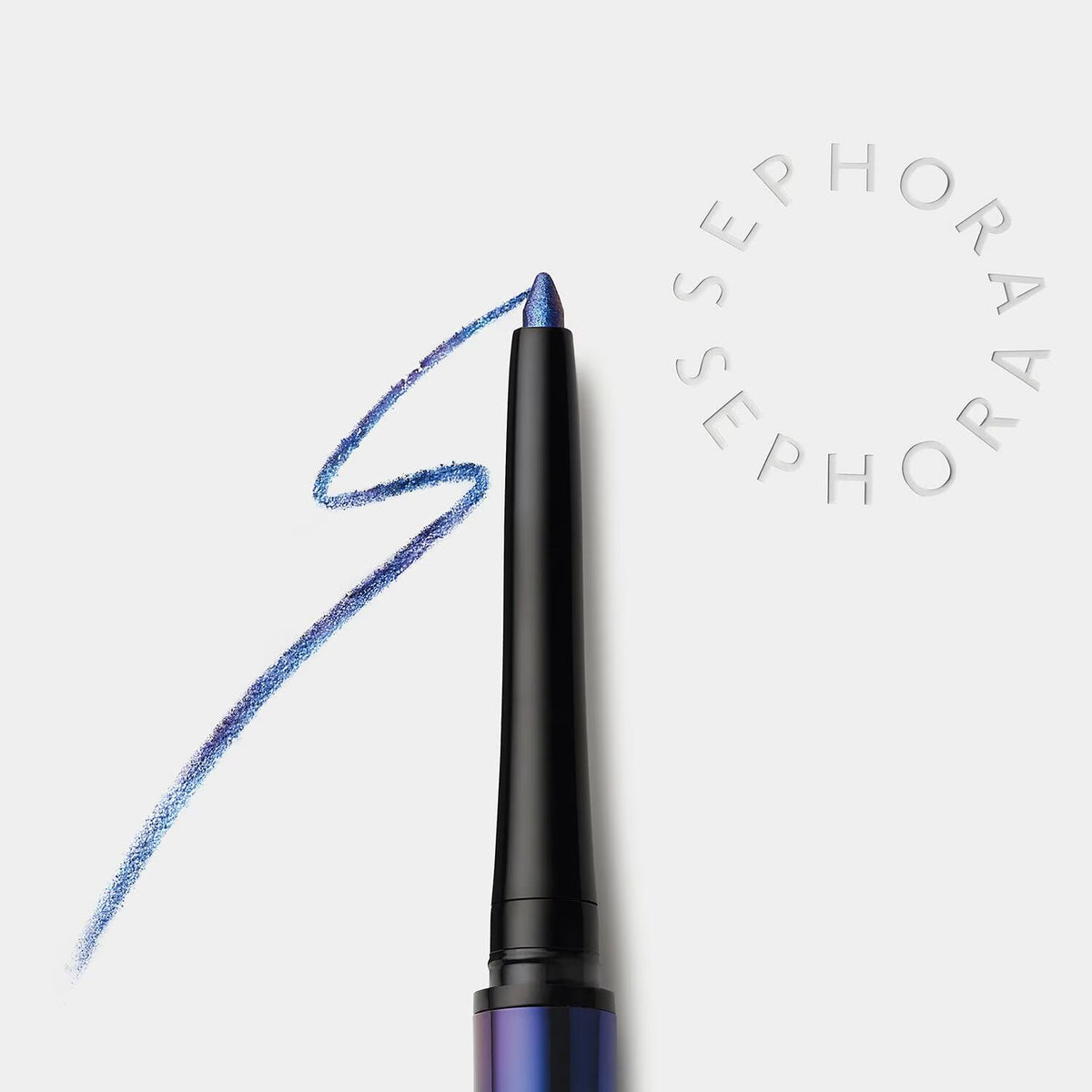 A close-up of a blue eyeshadow or eyeliner pencil with a black barrel, shown next to a blue swatch on a light gray background. The word 'SEPHORA' appears in a circular watermark on the right.