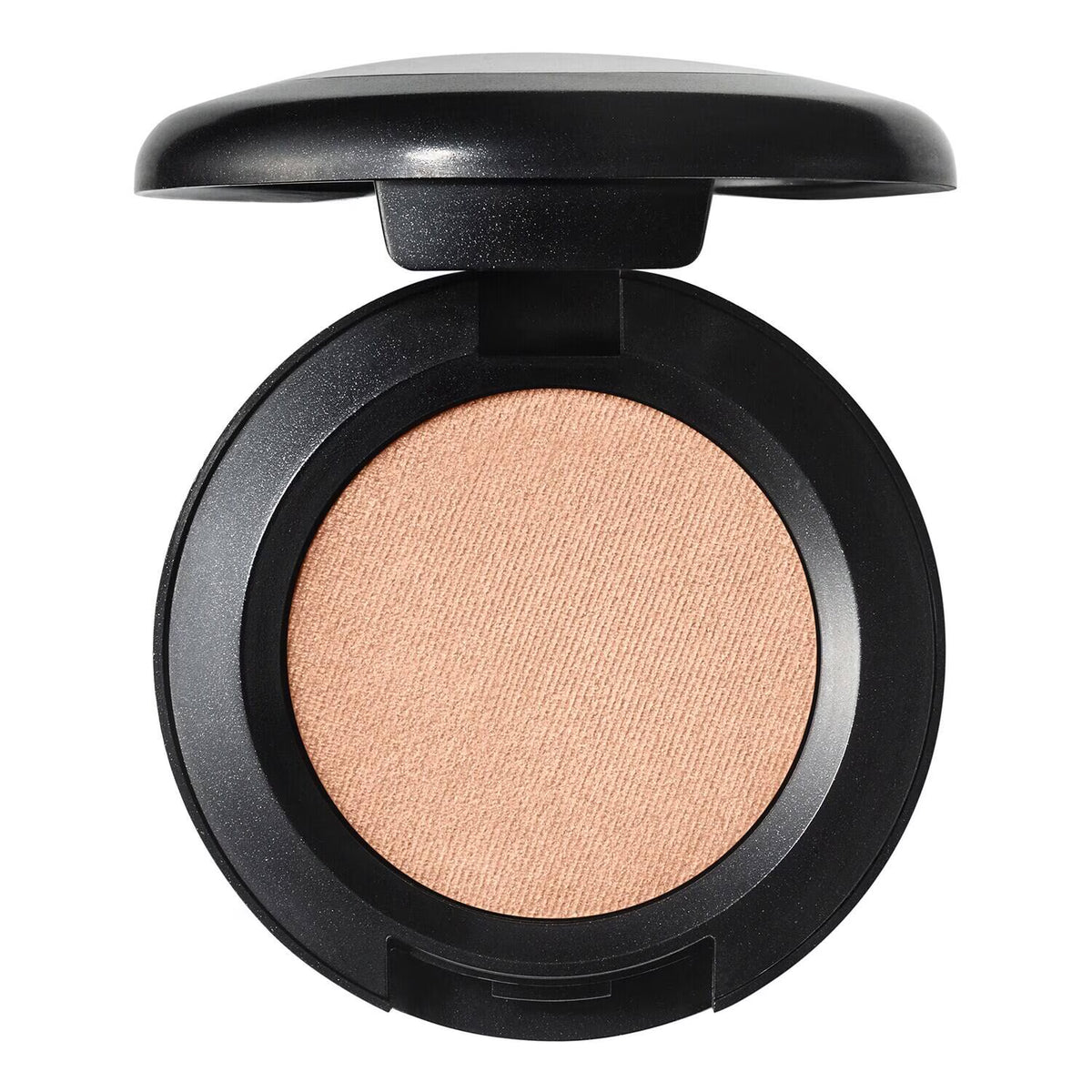 An open round makeup compact with a black casing and a single-pan pressed powder in a warm peach-beige shade, shown on a plain white background.
