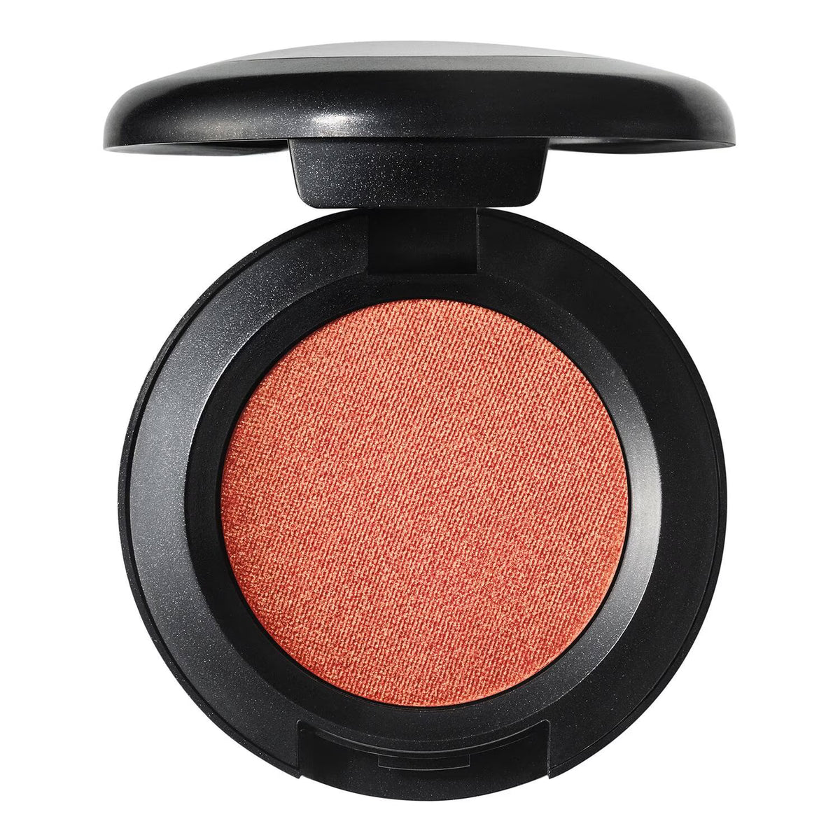 An open round makeup compact showing a textured, shimmering peachy-orange pressed powder, set against a solid white background.