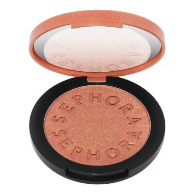 An open Sephora eyeshadow compact showing the 'Sephora' shadow in a shimmering coppery rose shade, with the peach-colored inner lid and black outer case visible against a white background.