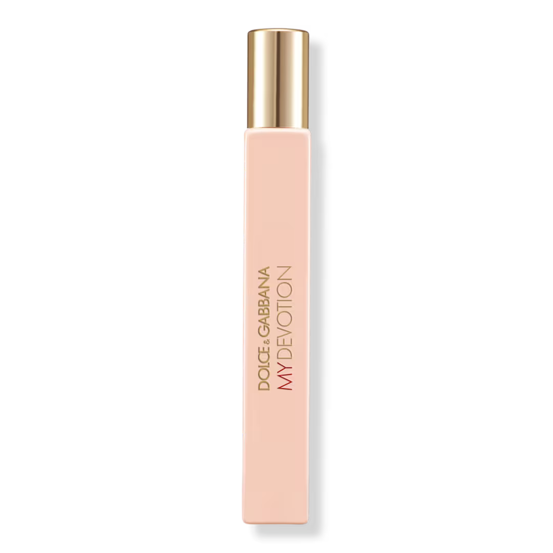 Dolce Gabbana My Devotion perfume bottle in a pale peach-pink color with a metallic gold cap, shown on a clean white background.