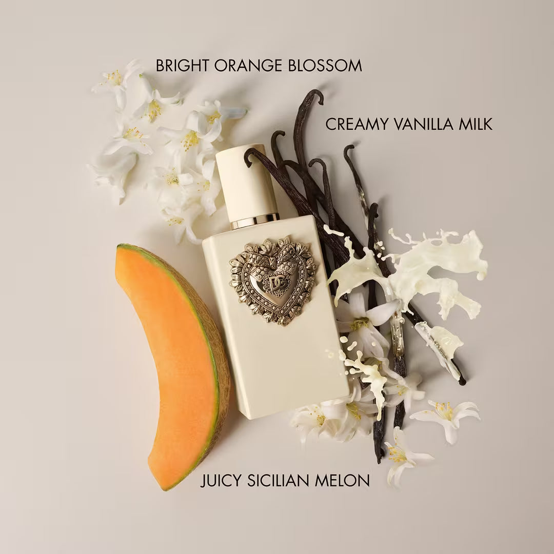 A perfume bottle labeled 'Bright Orange Blossom' and 'Creamy Vanilla Milk' is styled with a slice of melon, white blossoms, vanilla beans, and milk splashes on a light beige background. Text at the bottom reads 'Juicy Sicilian Melon.