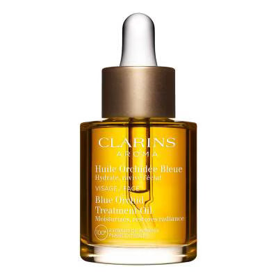 Clarins Aromas Blue Orchid Treatment Oil in a clear glass dropper bottle with amber-colored oil, a metallic gold collar, and a white rubber dropper cap, shown on a plain white background.