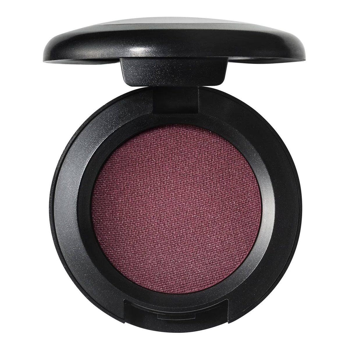 An open round makeup compact showing a textured mauve-purple eyeshadow or powder, set in a black compact against a plain white background.