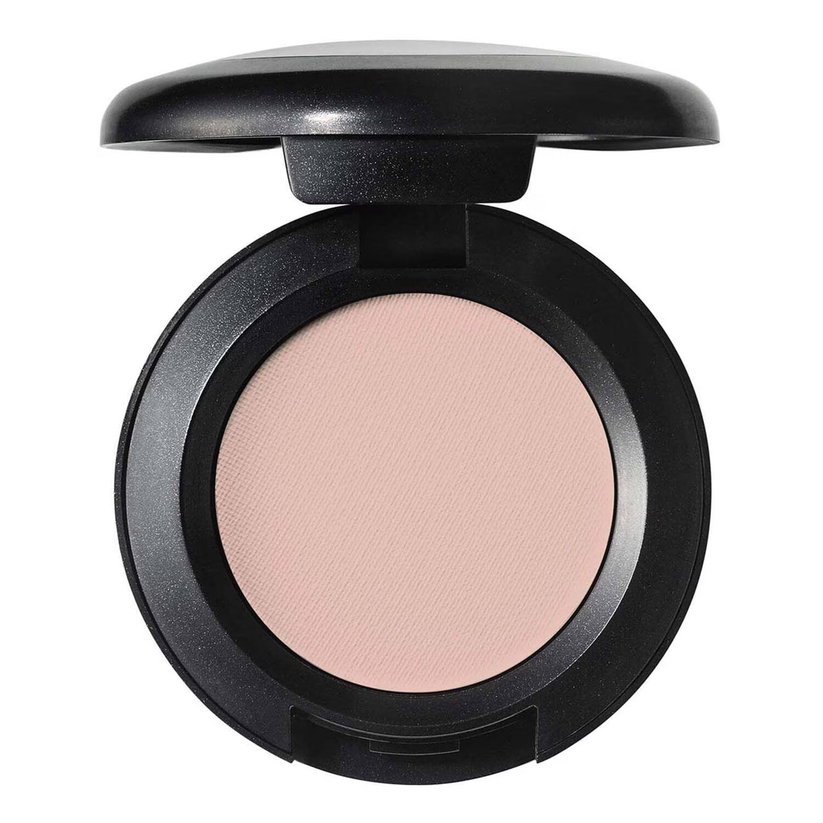 An open round makeup compact with a black casing and a light peach-pink pressed powder, shown on a plain white background.