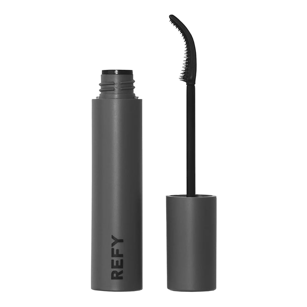 A dark gray cosmetic tube with the brand name REFY printed vertically in black, shown next to its cap and curved spoolie wand applicator on a solid white background.