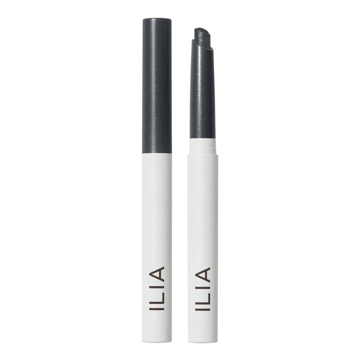 Two ILIA cosmetic pencils shown upright on a white background, one closed and one open, both with white barrels, dark gray caps, and the ILIA logo printed vertically near the bottom.