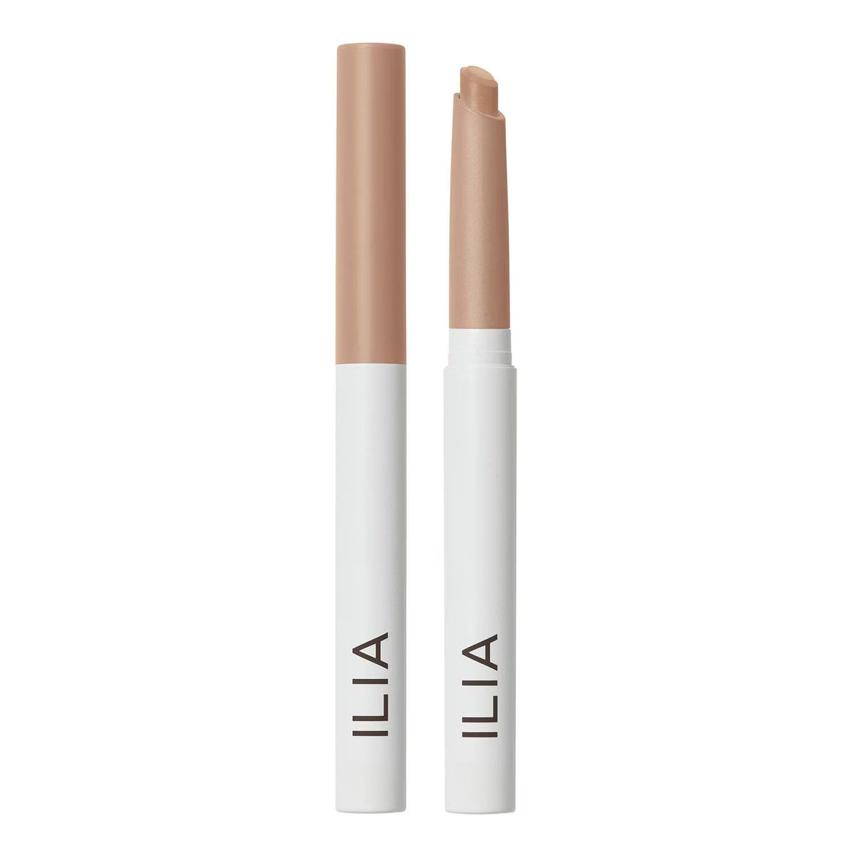Two ILIA cosmetic stick tubes standing upright on a white background, one closed and one open to show the tip. The product is a light beige/nude color with a white lower barrel and black ILIA branding.