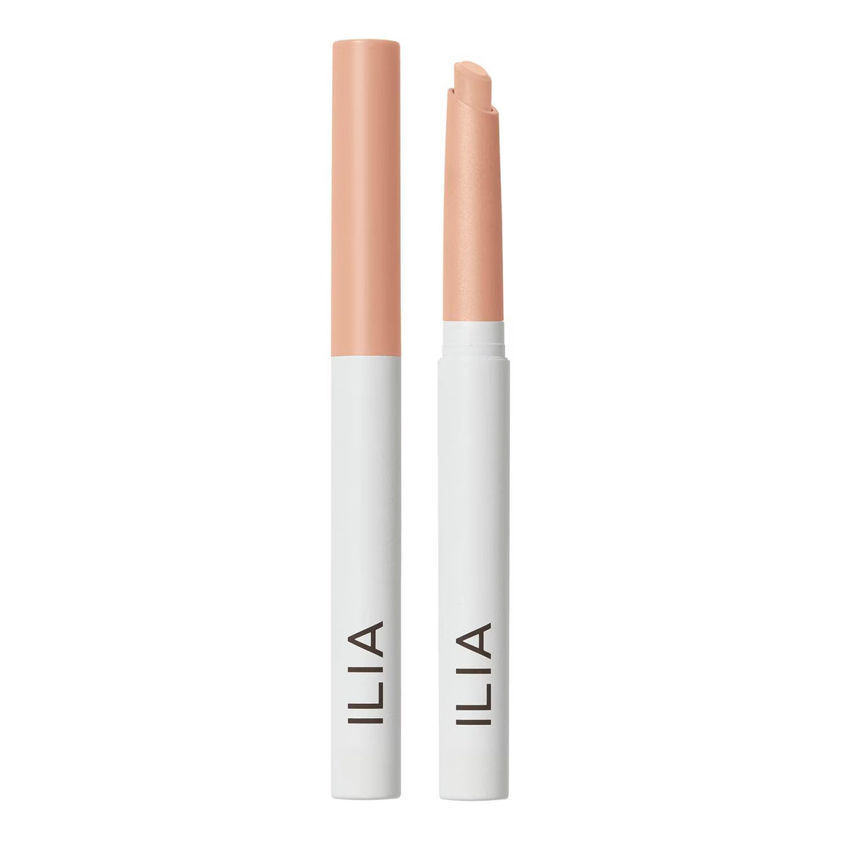 Two ILIA lip color pencils standing upright on a white background, one closed and one open, both showing a light peach-pink shade.