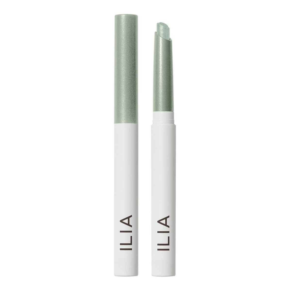 Two ILIA lip balm tubes standing upright on a white background, one closed and one open, both showing a pale mint green balm stick and a metallic pale green cap, with the brand name ILIA printed vertically in black on the white tubes.