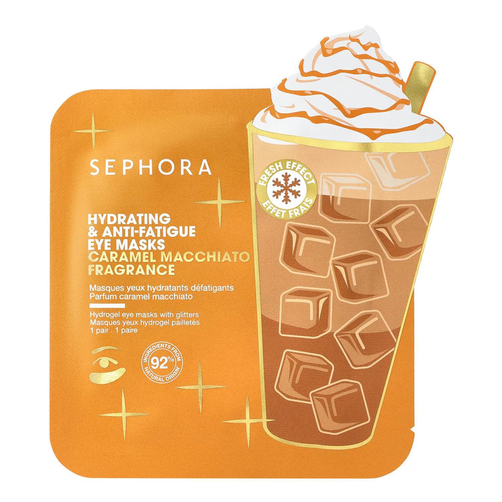 Sephora Hydrating & Anti-Fatigue Eye Masks Caramel Macchiato fragrance, featuring an orange pouch with white text alongside an illustration of a caramel macchiato coffee cup with whipped cream and ice cubes.