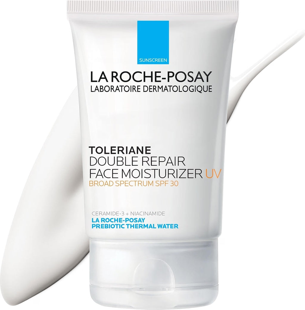 A white squeeze tube of La Roche-Posay Toleriane Double Repair Face Moisturizer UV with a blue and orange label, shown against a white background with a soft white brushstroke graphic.