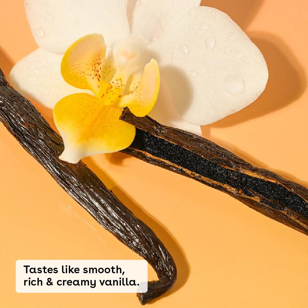 Vanilla beans with a white orchid on an orange background