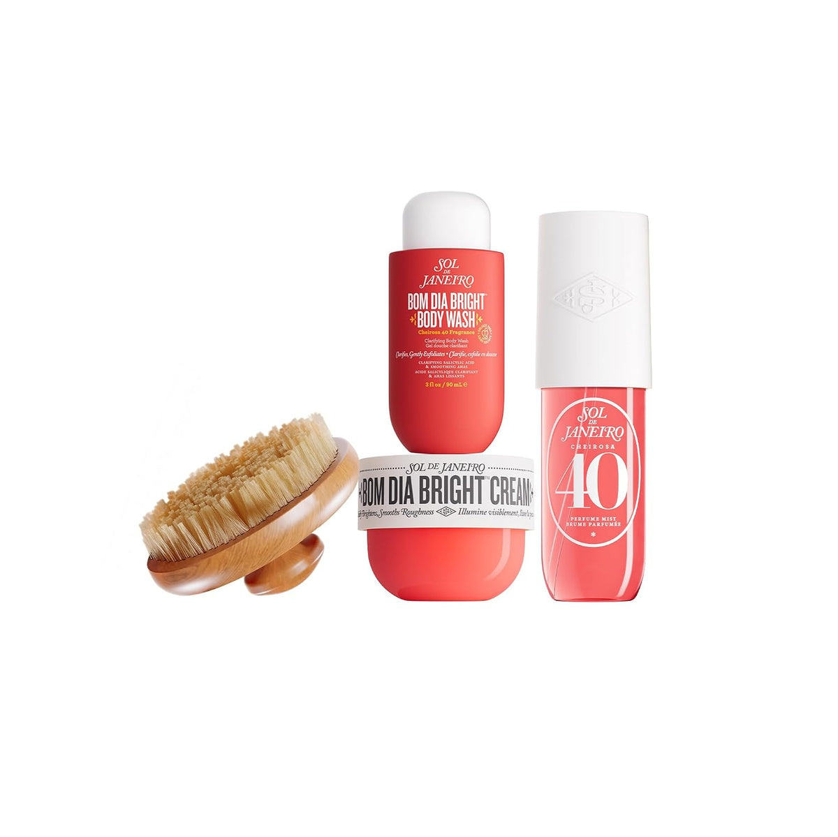 A three-piece body care set by GEL JANEIRO on a white background, including a wooden-handled natural bristle brush, a red body wash bottle, a red bright cream jar, and a red body oil bottle with a white cap.