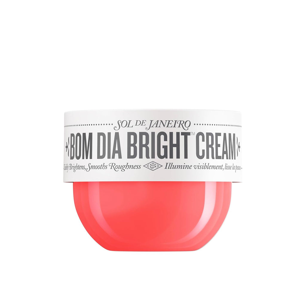 Coral-colored cream container with a white label on a white background