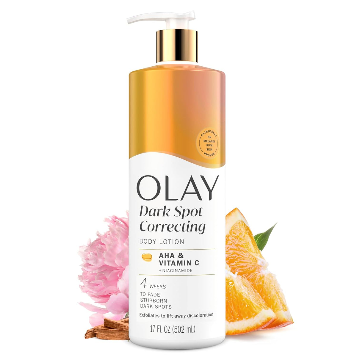 Olay Dark Spot Correcting Body Lotion with pump, pink flower, and orange slice on a white background