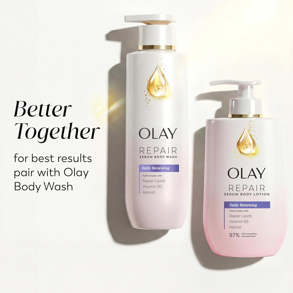 Two Olay Repair serum body wash products on a white background with promotional text. The taller bottle on the left is white with a gold droplet logo and purple label accents, and the shorter bottle on the right is pale pink with the same design.
