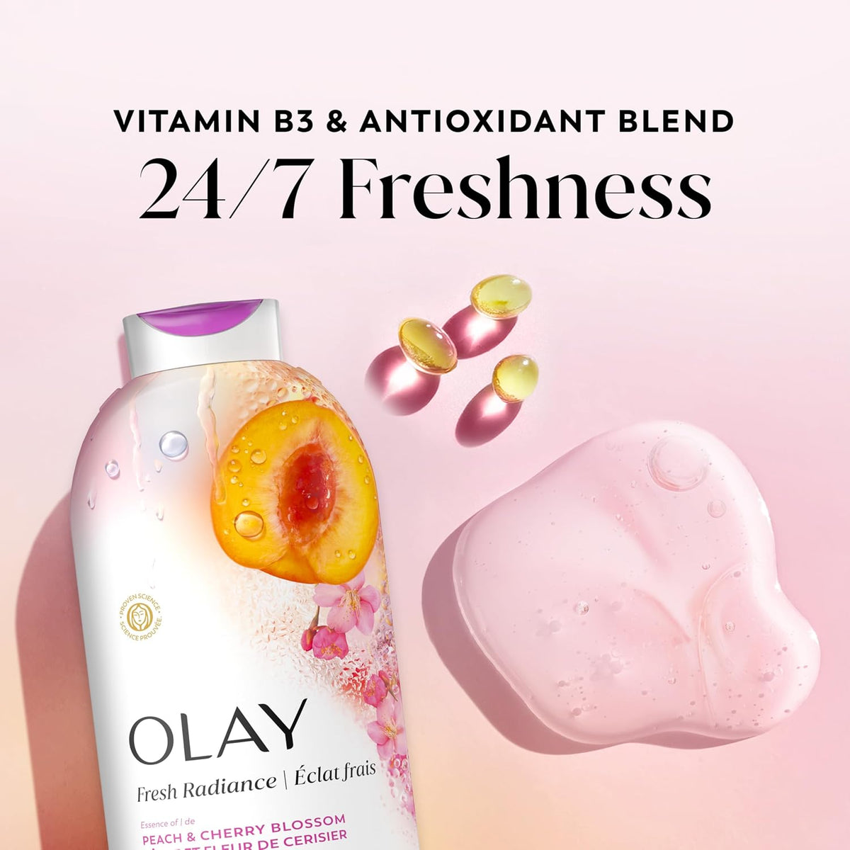 Olay Fresh Radiance Peach & Cherry Blossom Vitamin B3 & Antioxidant Blend serum bottle shown next to a pink heart-shaped bar of soap and three yellow vitamin capsules on a soft pink background, with text reading 'VITAMIN B3 & ANTIOXIDANT BLEND 24/7 Freshness'.