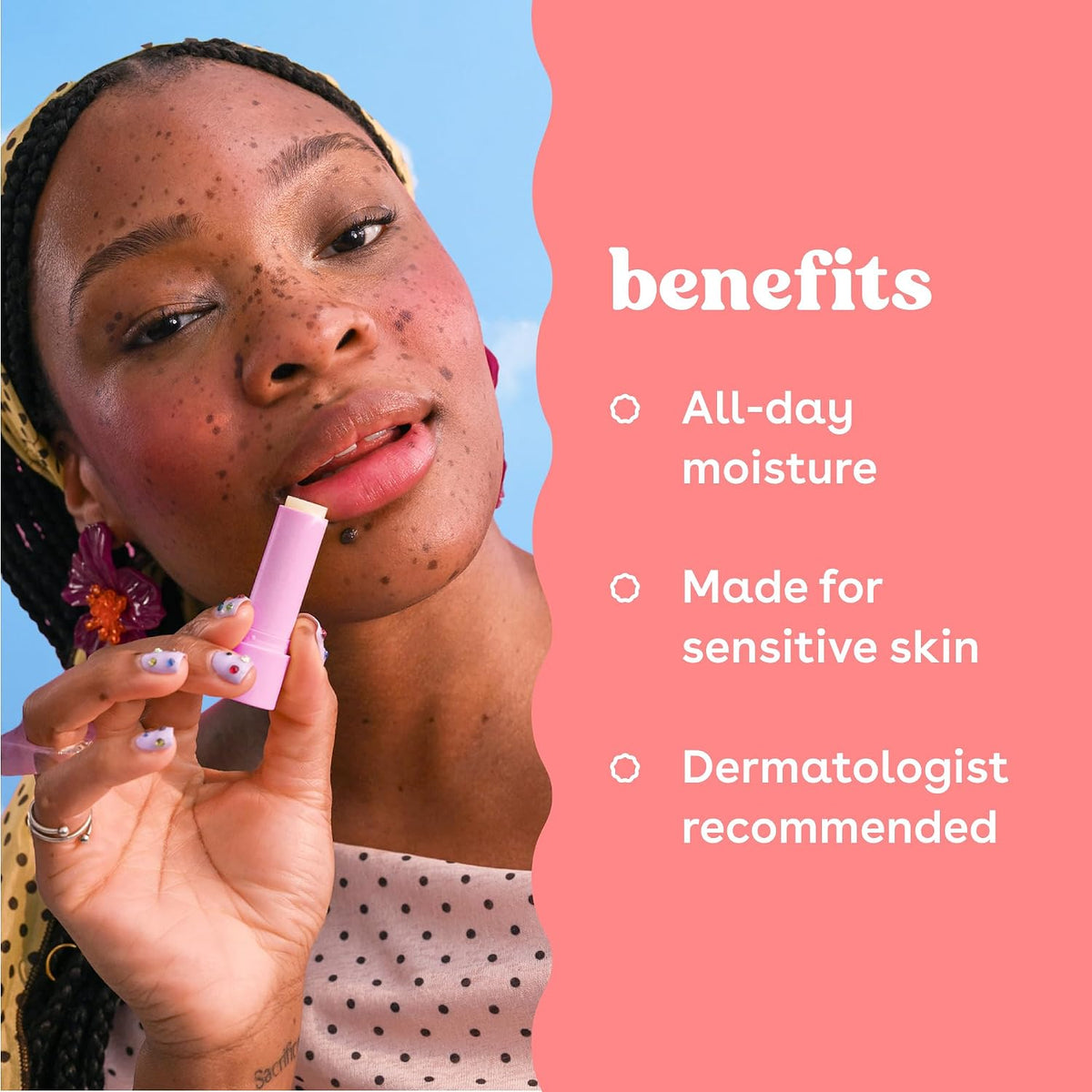 A woman with freckles applies a pink lip product while the right side of the image features a coral pink panel with white text listing benefits: 'All-day moisture', 'Made for sensitive skin', and 'Dermatologist recommended'.