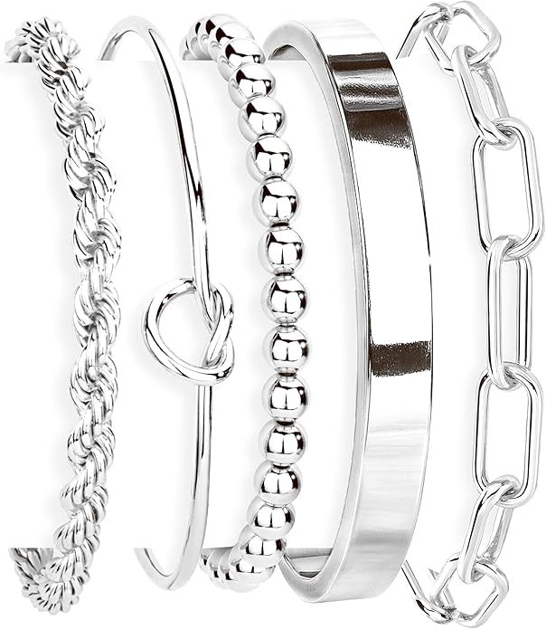 Set of silver bangles with different designs on a white background
