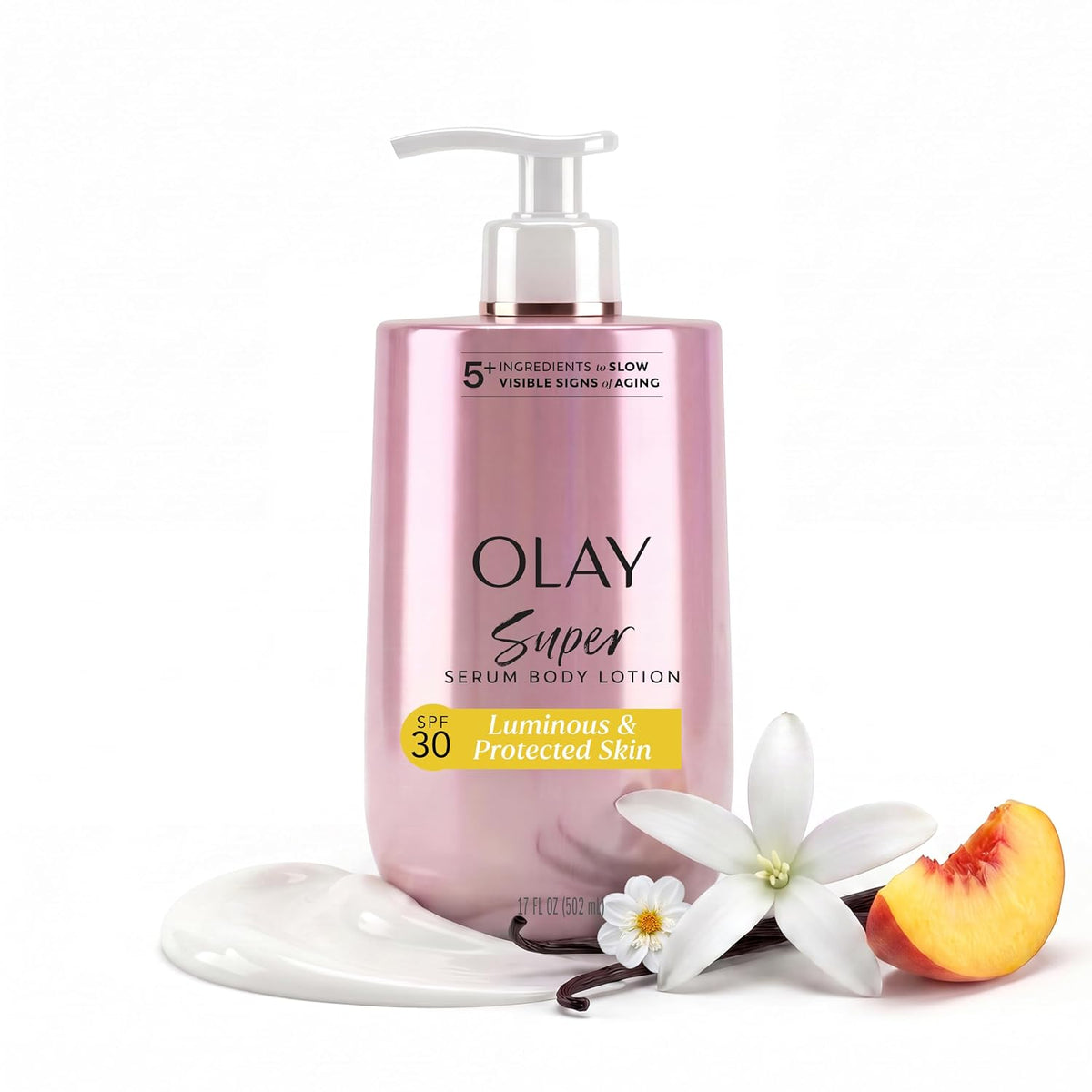 Olay Super Serum Body Lotion in a metallic pink pump bottle, styled with a dollop of white lotion, a white flower, a vanilla bean, and a peach slice on a white background.