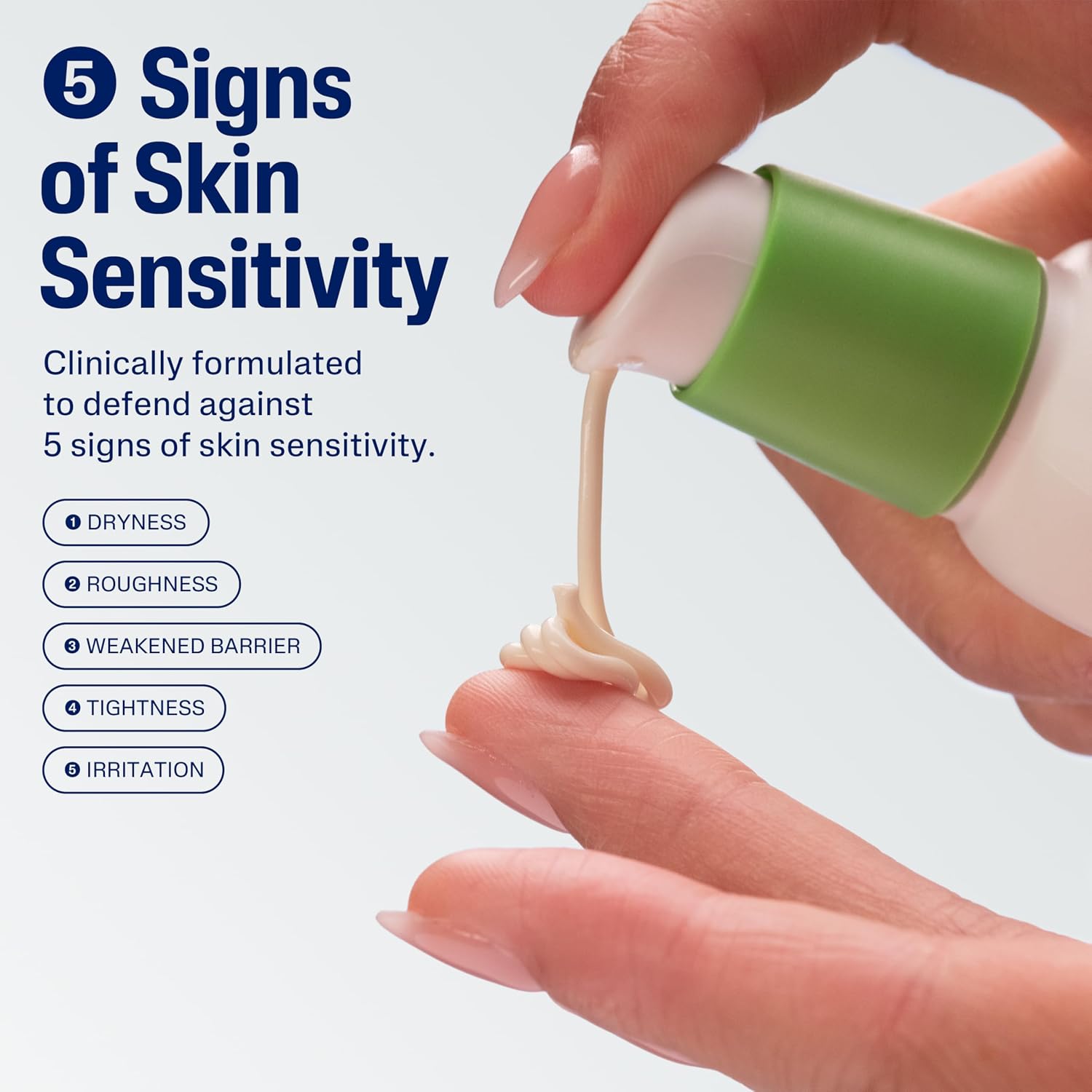 Hand holding a green and white skincare product with text about skin sensitivity.