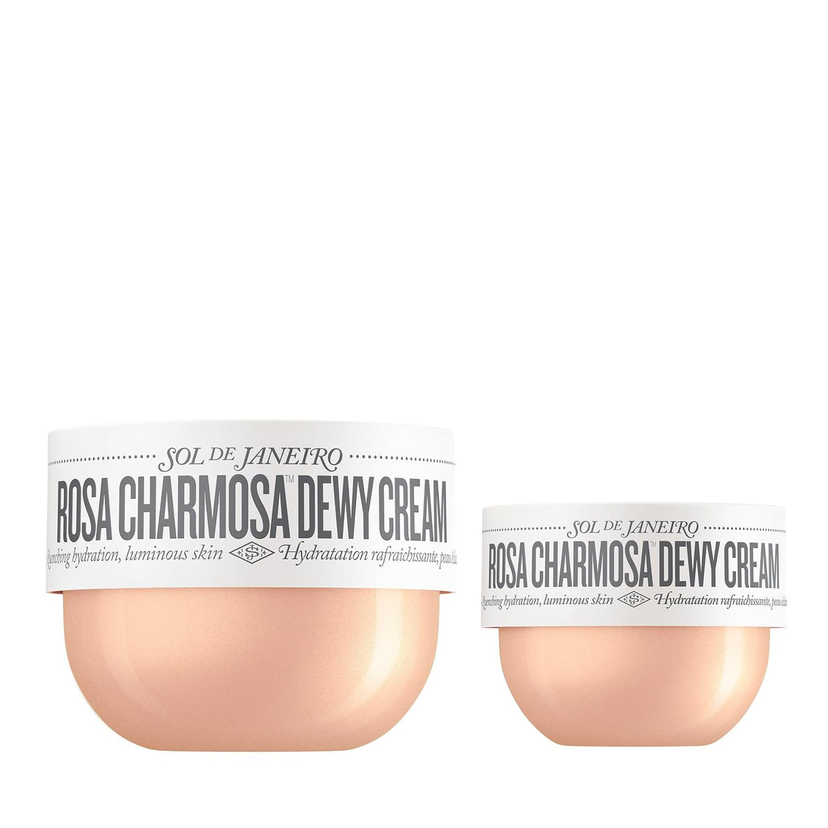 Two cosmetic jars of Sol de Janeiro Rosa Charmosa Dewy Cream on a plain white background, one larger jar and one smaller jar, both with white labels and peach-colored cream visible at the bottom.