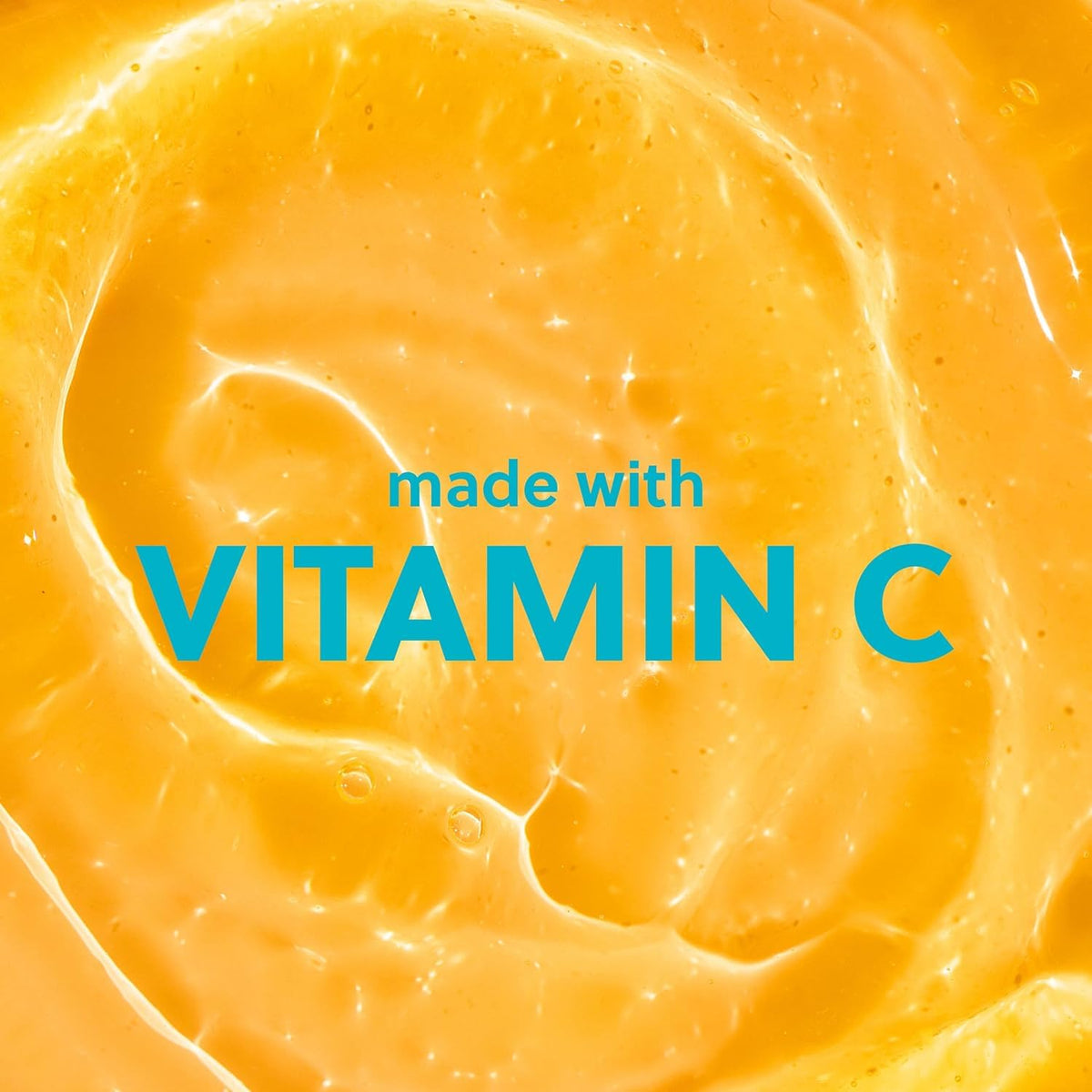 Close-up of a yellow-orange textured substance with 'made with VITAMIN C' text overlay.