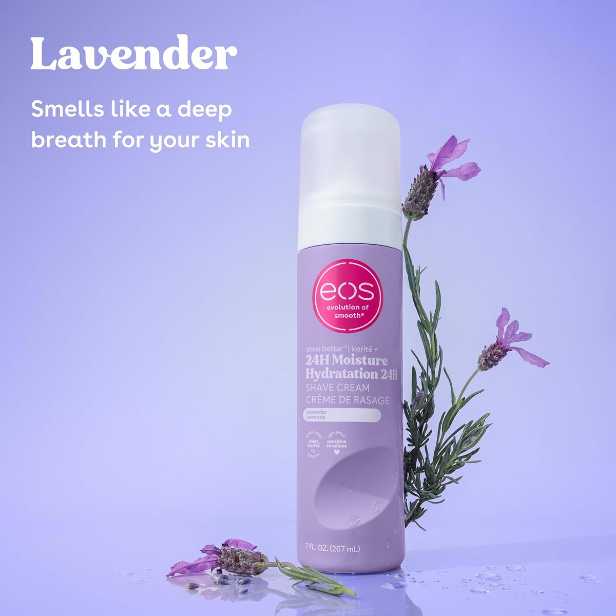 A bottle of EOS Lavender 24H Moisture Hydration Shave Cream stands on a reflective surface with lavender sprigs and text on a light lavender background.