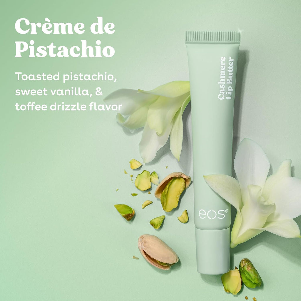 A tube of EOS Crème de Pistachio lip balm is displayed on a light mint green background with white orchid flowers and pistachio pieces. The text on the left reads 'Crème de Pistachio' and 'Toasted pistachio, sweet vanilla, & toffee drizzle flavor'.