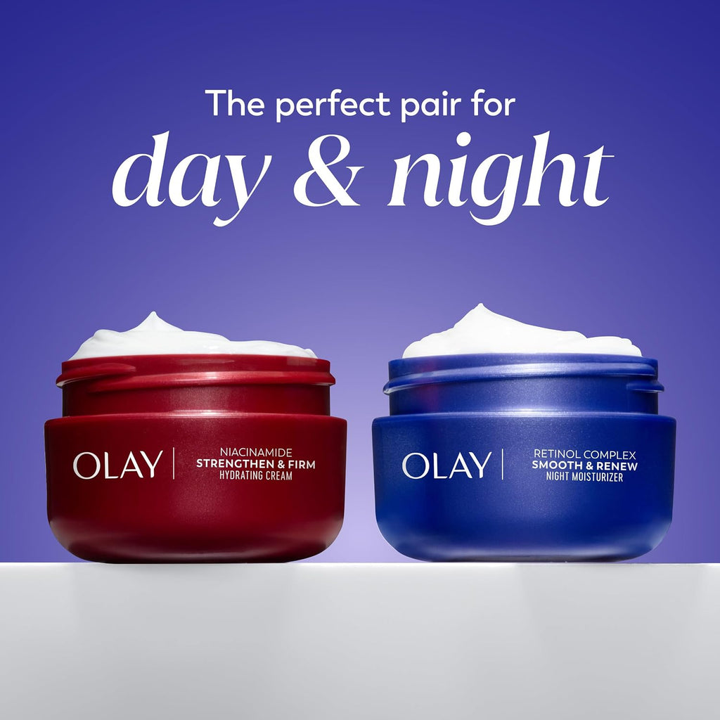 Two Olay skincare jars, one red and one blue, on a white surface with a purple background.
