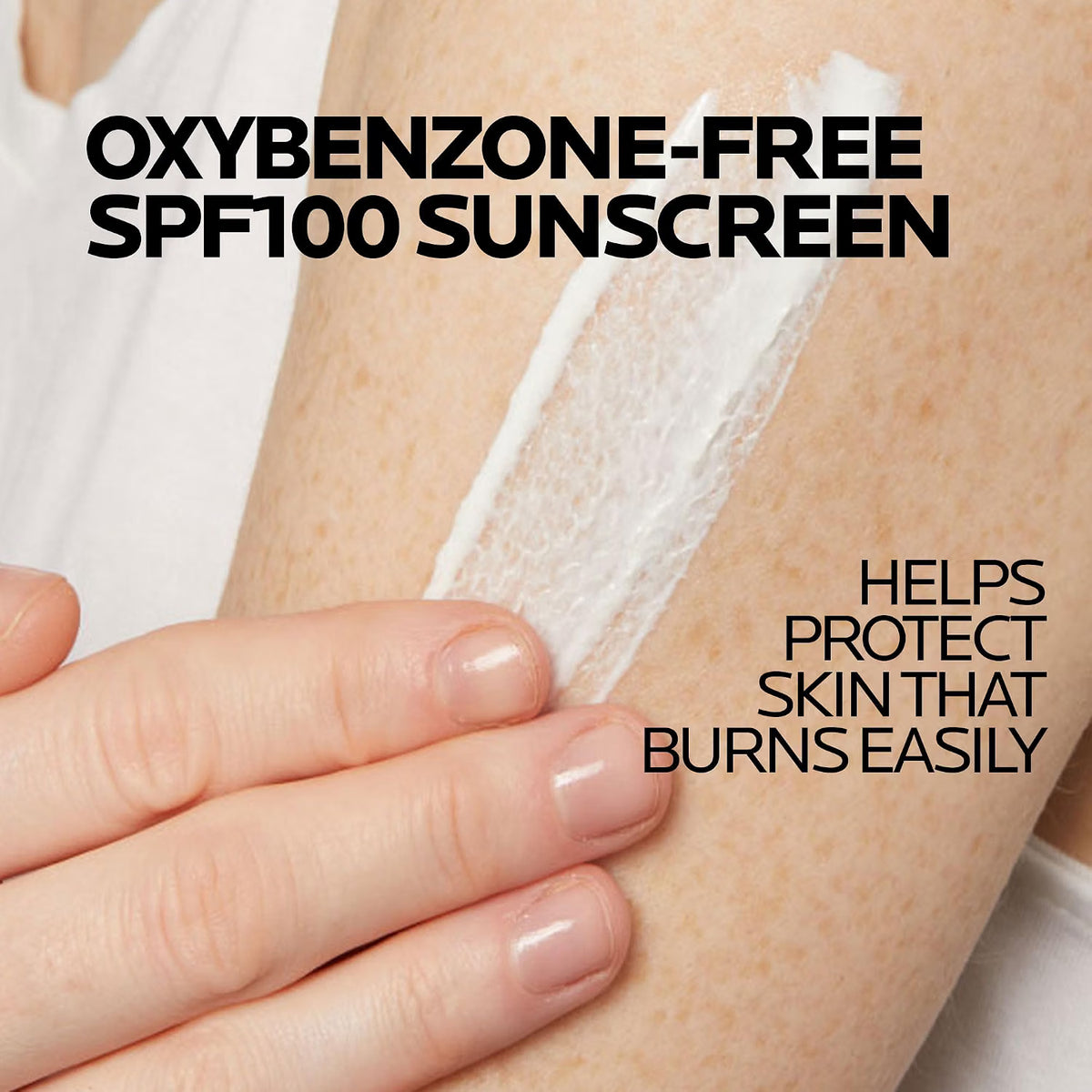 Sunscreen application on a person's arm with text about oxybenzone-free SPF100 sunscreen.