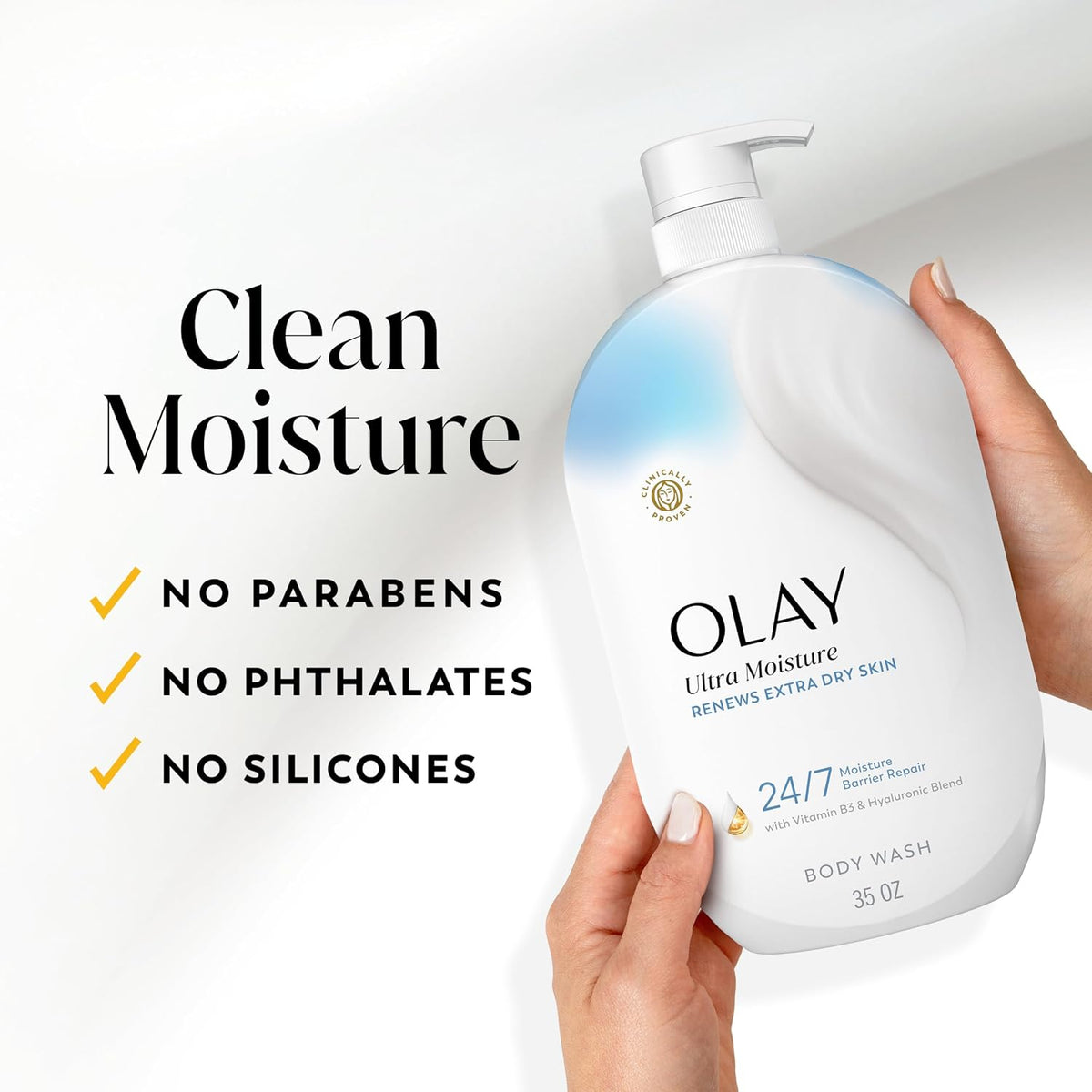 Olay body wash bottle held by a hand with product features listed on a white background