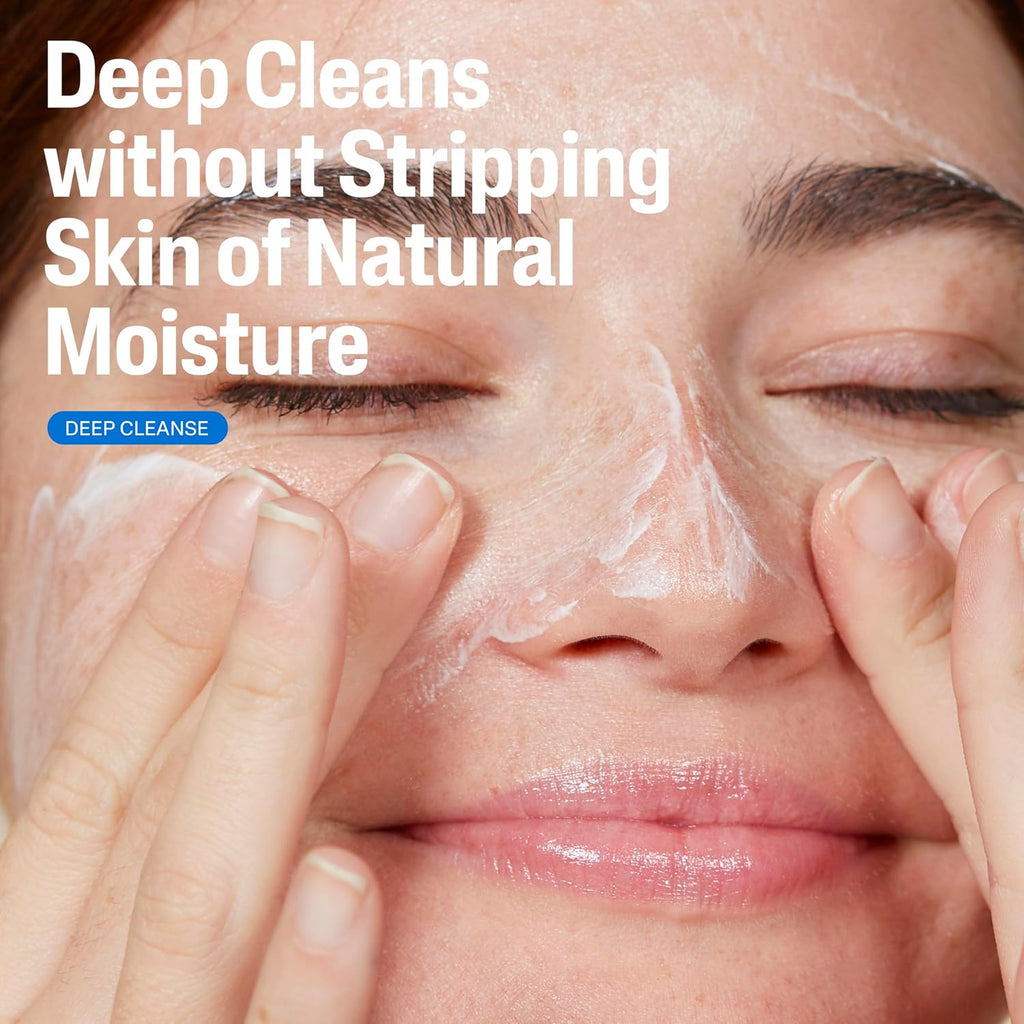 Close-up of a woman's face with white cleanser applied, her fingers touching her cheeks, with the text 'Deep Cleans without Stripping Skin of Natural Moisture' and a blue 'DEEP CLEANSE' label.