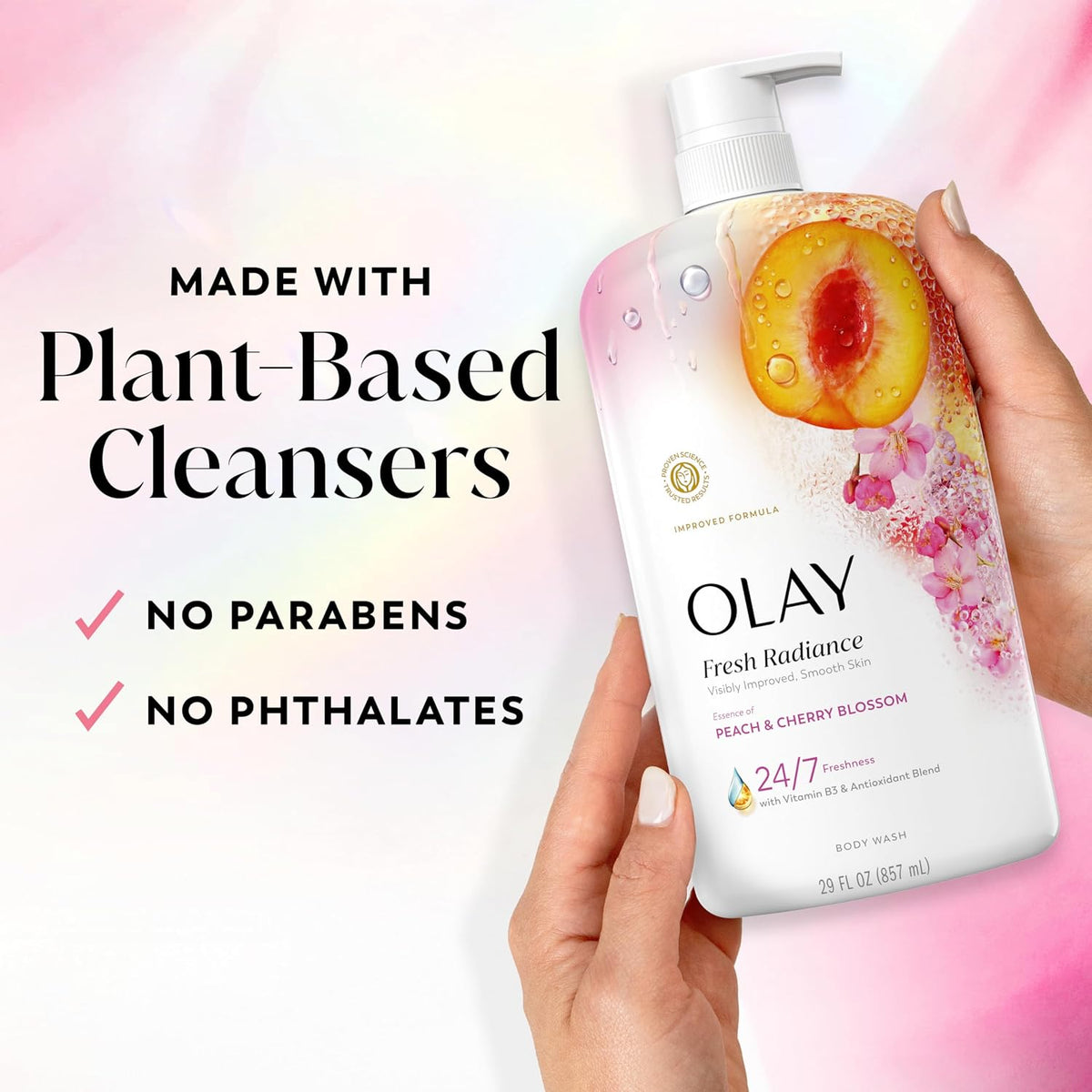 OLAY Fresh Radiance cleanser with peach design held by a hand, on a light pink background.