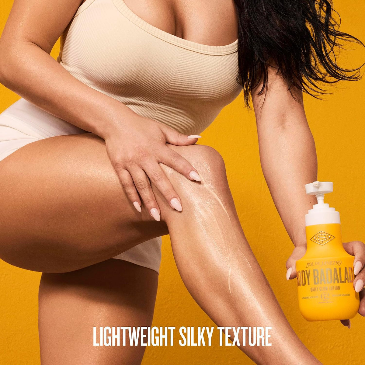 A woman in a beige ribbed tank top and white shorts applies a white body butter cream to her leg while holding a yellow bottle labeled 'BODY BATHA'. The background is a solid bright yellow, with the text 'LIGHTWEIGHT SILKY TEXTURE' at the bottom.
