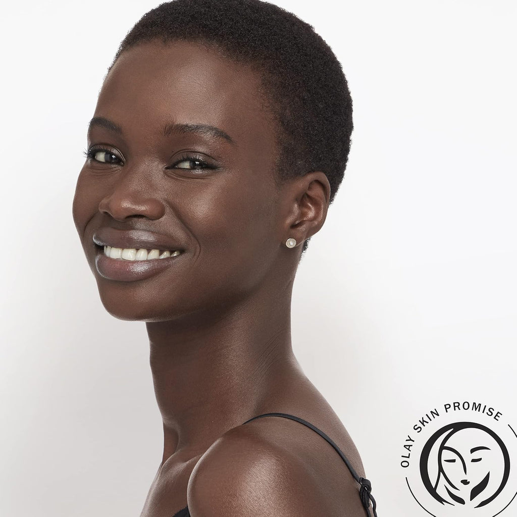 Woman with a short haircut on a white background with Olan Skin Promise logo.
