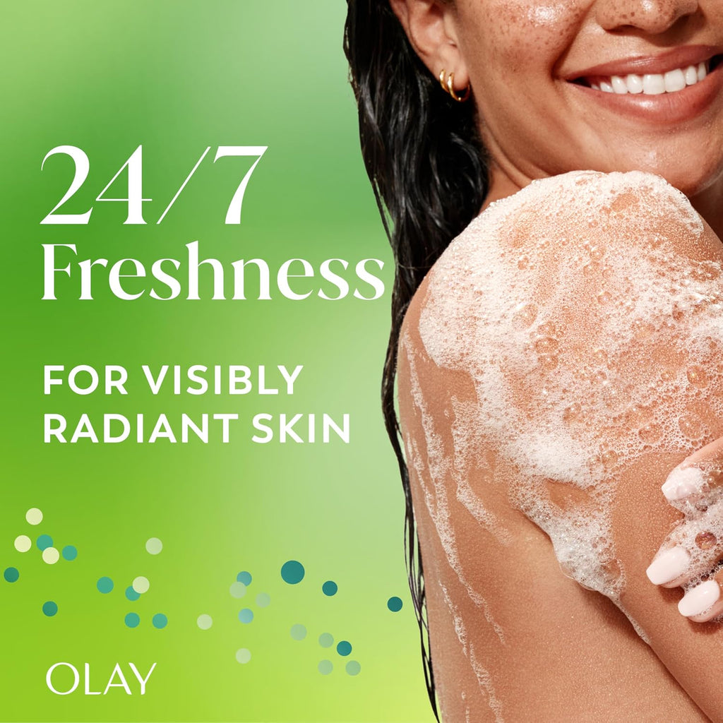 Promotional skincare graphic with a smiling woman on the right, partially shown from the chest up, with wet dark hair and white foam on her shoulder. Large text on the left reads '24/7 Freshness FOR VISIBLY RADIANT SKIN' and the brand 'OLAY' appears at the bottom left.