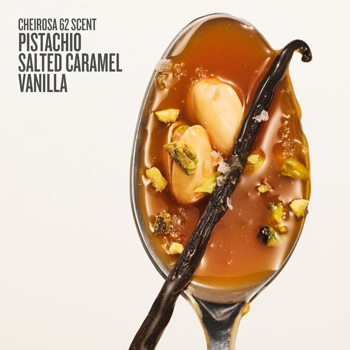 Spoon with salted caramel sauce, vanilla bean, and pistachios on a white background