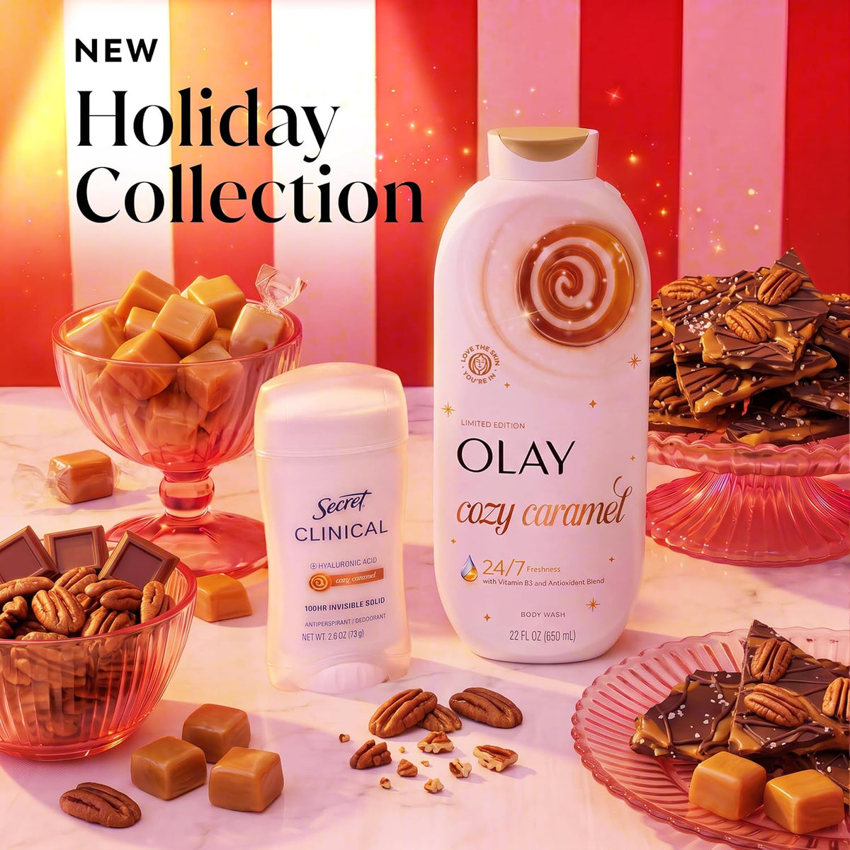 Olay and Secret Clinical Holiday Collection products displayed with caramel candies, chocolate bark, and pecans on a pink and white striped background. The products include a large Olay Cozy Caramel body wash bottle and a Secret Clinical Ozone Deodorant stick.