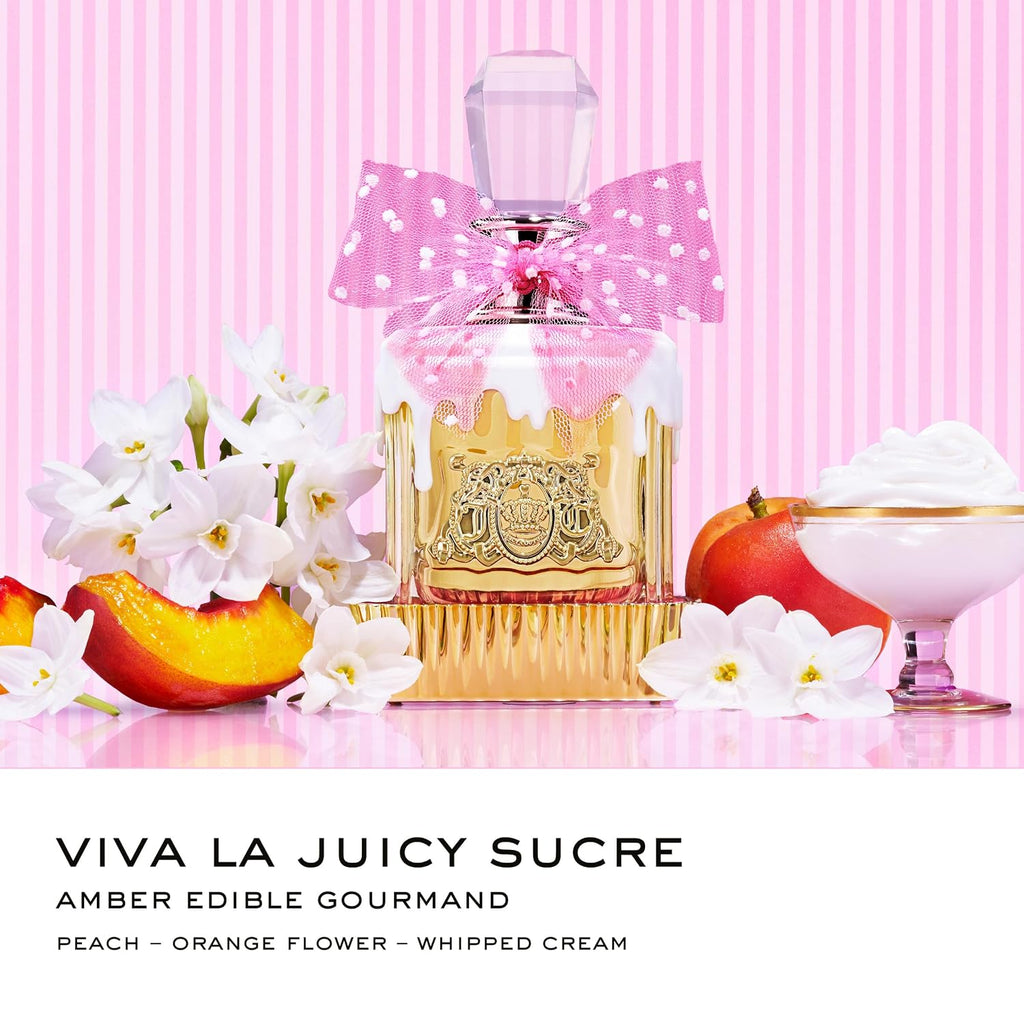 Perfume bottle with pink bow, fruits, and flowers on a pink background