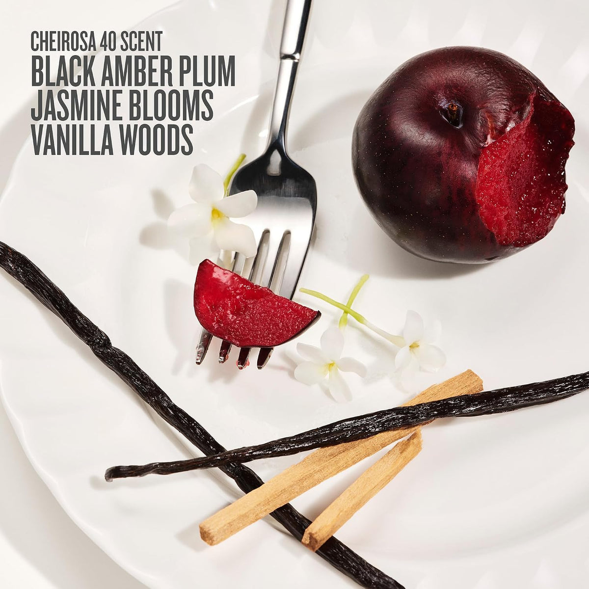 Fruit and vanilla stick with a fork on a white background, featuring text about a perfume scent.