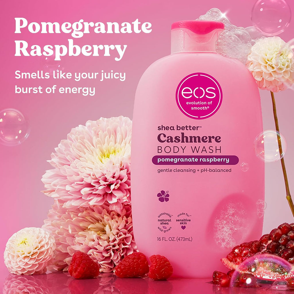 Pink bottle of eos shea butter cashmere body wash with pomegranate raspberry flavor on a pink background with flowers and berries.