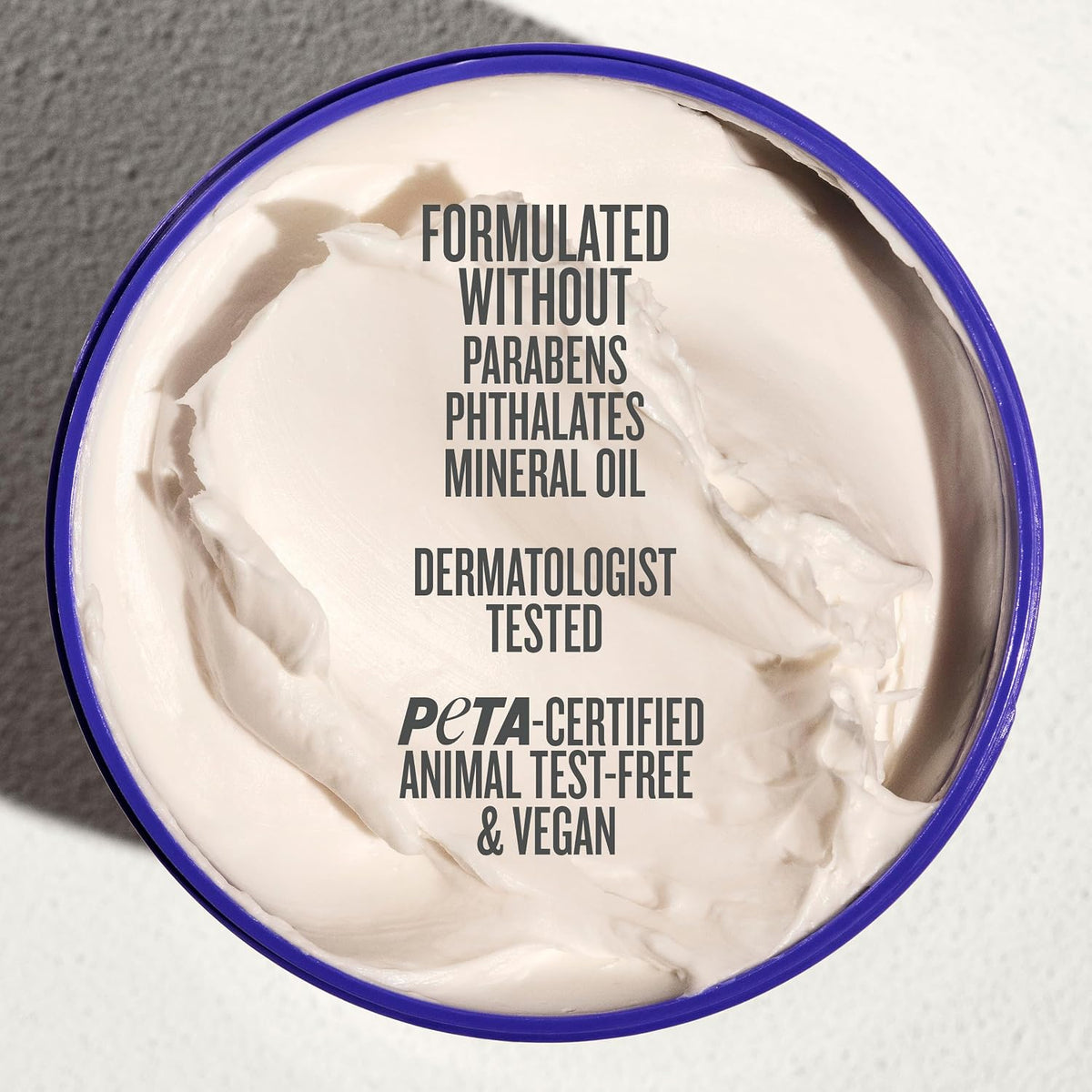 Jar of cream with certification text on a neutral background