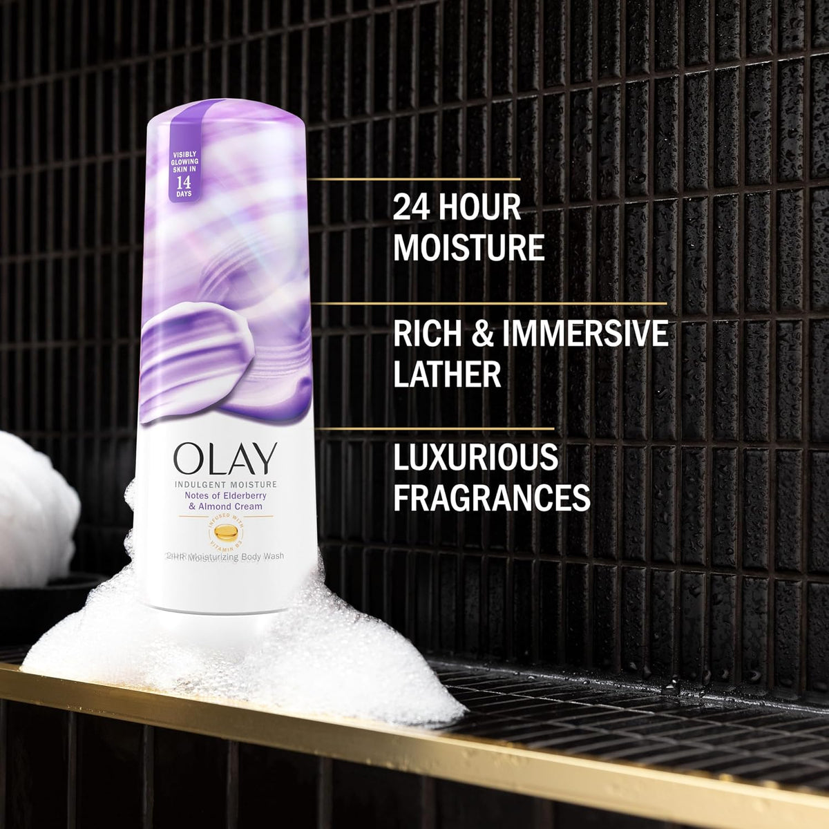 Olay沐浴露瓶子在泡沫中，背景是黑色的瓷砖墙，带有产品特点文字。