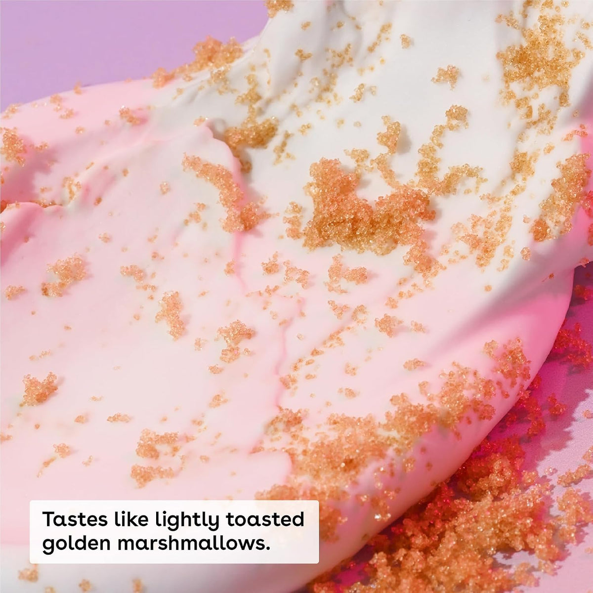 Close-up of pink dessert with gold sprinkles on a purple background