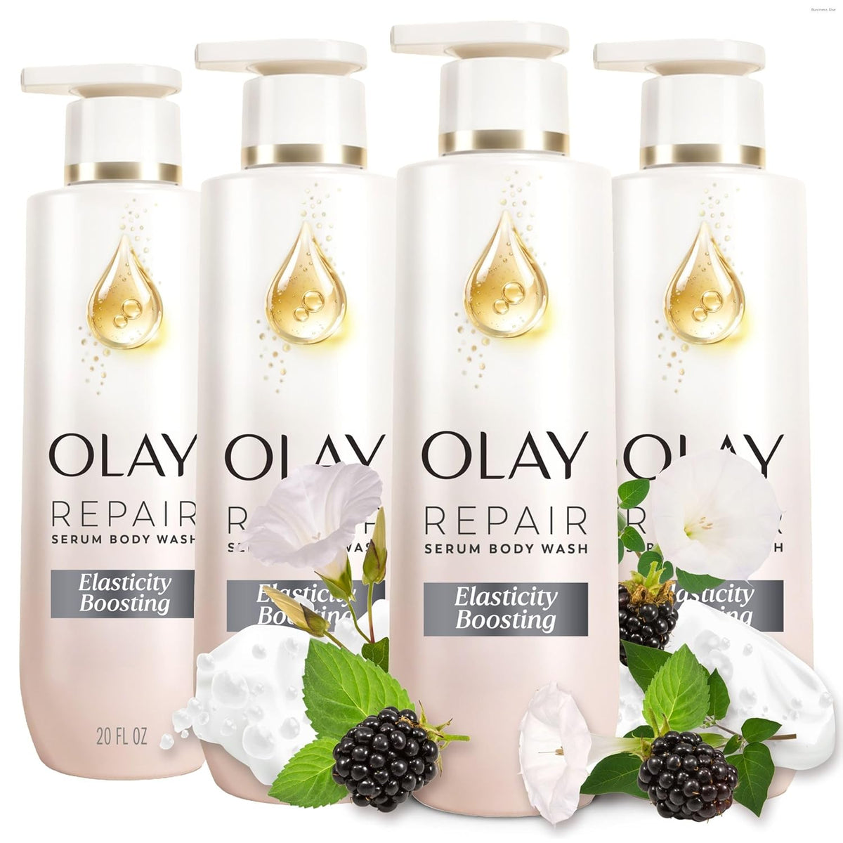 Four Olay Repair Serum Body Wash bottles arranged together on a white background, with decorative white flowers, blackberries, and green leaves in front of the lower bottles.