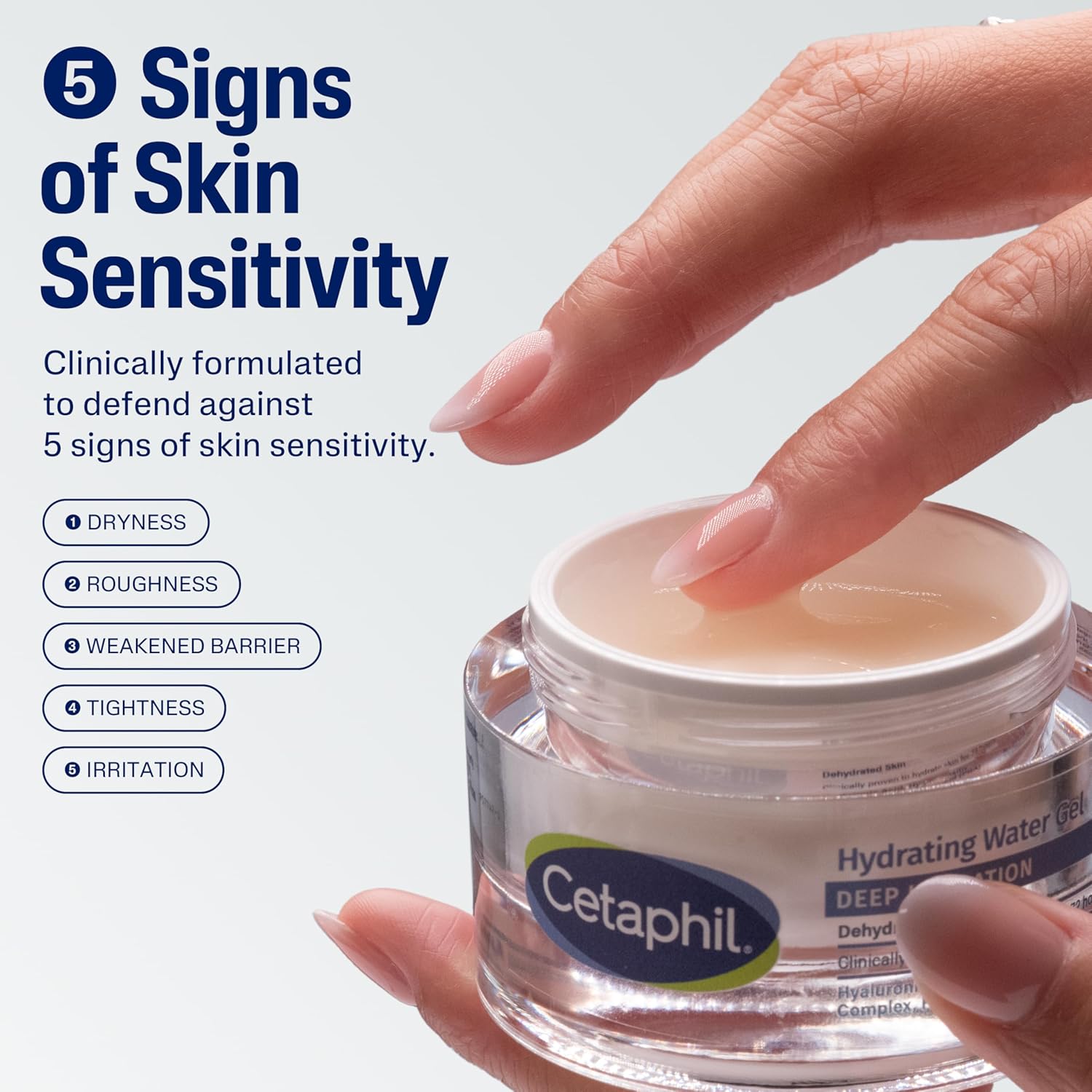Cetaphil jar with a hand touching the lid, against a light gray background.